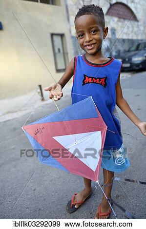 "Young boy holding a kite in a slum or favela, Jacarezinho favela, Rio de Janeiro, Rio de Janeiro State, Brazil, South America" View Large Photo Image Stock Photo - "Young boy holding a kite in a slum or favela, Jacarezinho favela, Rio de Janeiro, Rio de Janeiro State, Brazil, South America". Fotosearch