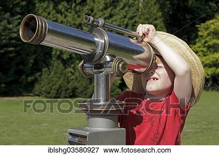 "Young boy looking through a telescope, Bergpark Wilhelmshohe, Kassel, Hesse, Germany, Europe" View Large Photo Image Stock Photo - "Young boy looking through a telescope, Bergpark Wilhelmshohe, Kassel, Hesse, Germany, Europe". Fotosearch