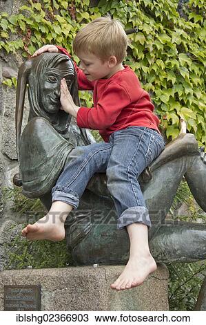 "Young boy sitting on the Eulenspiegel statue, Moelln, Schleswig-Holstein, Germany, Europe" View Large Photo Image Stock Image - "Young boy sitting on the Eulenspiegel statue, Moelln, Schleswig-Holstein, Germany, Europe". Fotosearch