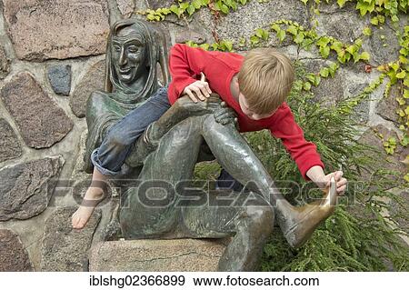 "Young boy sitting on the Eulenspiegel statue, Moelln, Schleswig-Holstein, Germany, Europe" View Large Photo Image Stock Photo - "Young boy sitting on the Eulenspiegel statue, Moelln, Schleswig-Holstein, Germany, Europe". Fotosearch