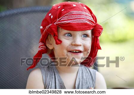 Young boy wearing a scarf on his head with his mouth smeared with chocolate View Large Photo Image Stock Photo - Young boy wearing a scarf on his head with his mouth smeared with chocolate. Fotosearch