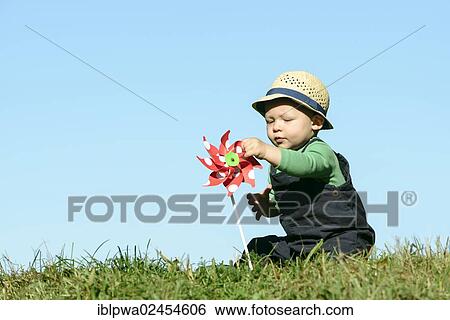 "Young boy with a pinwheel, symbolic image for alternative energy and sustainability" View Large Photo Image Stock Photograph - "Young boy with a pinwheel, symbolic image for alternative energy and sustainability". Fotosearch