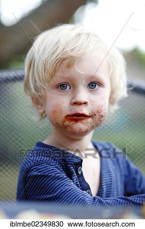 Young boy with his mouth smeared with chocolate View Large Photo Image Stock Image - Young boy with his mouth smeared with chocolate. Fotosearch