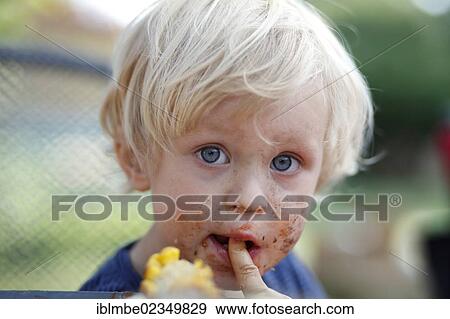 Young boy with his mouth smeared with chocolate View Large Photo Image Stock Photo - Young boy with his mouth smeared with chocolate. Fotosearch