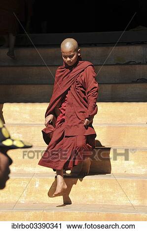 "Young Buddhist monk stepping out of a monastery, Full Moon Festival in December, Nyaung Shwe, Shan State, Myanmar, Burma, Asia" View Large Photo Image Stock Image - "Young Buddhist monk stepping out of a monastery, Full Moon Festival in December, Nyaung Shwe, Shan State, Myanmar, Burma, Asia". Fotosearch