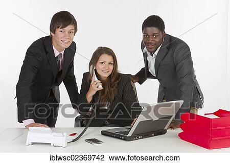Young business people in an office View Large Photo Image Stock Image - Young business people in an office. Fotosearch