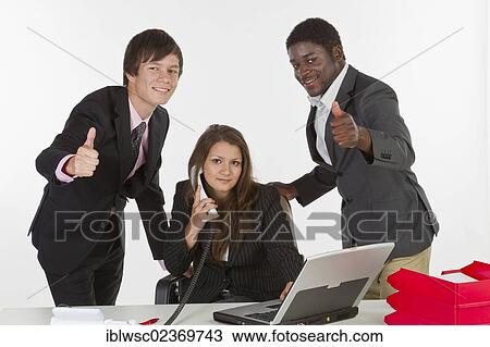 "Young business people in an office, men making a thumbs-up gesture" View Large Photo Image Stock Image - "Young business people in an office, men making a thumbs-up gesture". Fotosearch