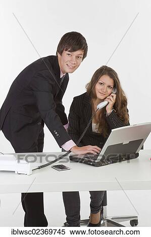 Stock Photography - Young business people in an office. Fotosearch