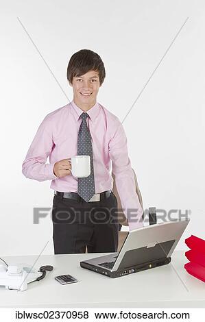 Stock Photo - Young businessman in the office. Fotosearch