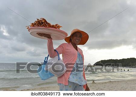 "Young Cambodian woman wearing a sun hat selling crabs and shrimps on the beach, Serendipity Beach, Sihanoukville, Preah Sihanuk, Cambodia, Asia" View Large Photo Image Stock Image - "Young Cambodian woman wearing a sun hat selling crabs and shrimps on the beach, Serendipity Beach, Sihanoukville, Preah Sihanuk, Cambodia, Asia". Fotosearch