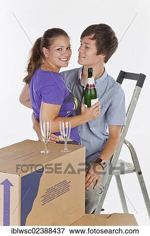 "Young couple, house moving, with a bottle of champagne" View Large Photo Image Stock Photo - "Young couple, house moving, with a bottle of champagne". Fotosearch