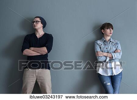 Stock Photo - "Young couple leaning on a wall, apart from each other, Mannheim, Baden-Wurttemberg, Germany, Europe". Fotosearch