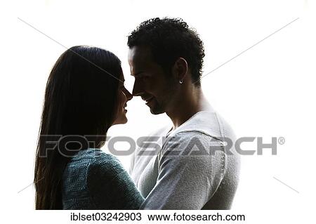 Stock Image - "Young couple looking into each other's eyes, backlit, Austria, Europe". Fotosearch