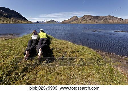 "Young couple lying on a meadow, Lake Alftavatn, Iceland, Europe" View Large Photo Image Stock Image - "Young couple lying on a meadow, Lake Alftavatn, Iceland, Europe". Fotosearch