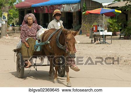 Stock Photography - "Young couple on a horse cart, Areyskat Village, a suburb of Phnom Penh, Cambodia, Southeast Asia, Asia". Fotosearch