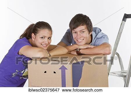 Stock Photo - Young couple on moving day. Fotosearch