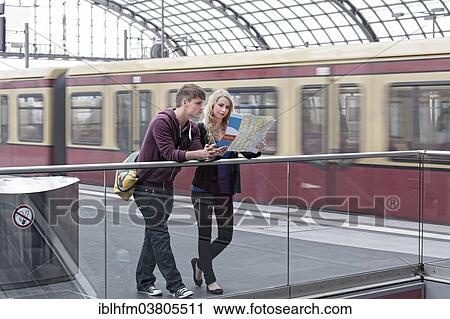 "Young couple standing on the platform and looking at a map, Berlin, Germany, Europe" View Large Photo Image Stock Image - "Young couple standing on the platform and looking at a map, Berlin, Germany, Europe". Fotosearch