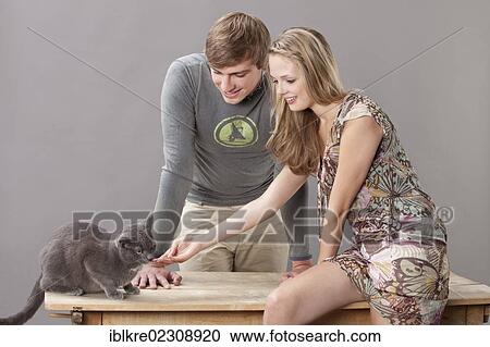 Stock Image - Young couple with cat. Fotosearch