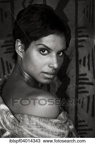 Stock Image - Young dark-skinned woman with a raised eyebrow. Fotosearch