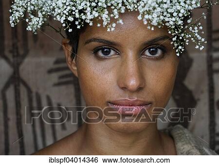 Stock Photograph - Young dark-skinned woman with flower wreath on head. Fotosearch