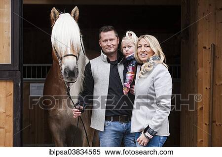 "Young family standing with a Tyrolean Haflinger in front of a stall, North Tyrol, Austria, Europe" View Large Photo Image Stock Photography - "Young family standing with a Tyrolean Haflinger in front of a stall, North Tyrol, Austria, Europe". Fotosearch