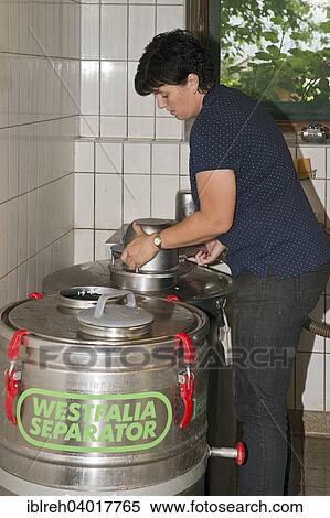 "Young farmer filling milk into transport tanks, Sprenger family farm, Schwaz District, Tyrol, Austria Family" View Large Photo Image Stock Photography - "Young farmer filling milk into transport tanks, Sprenger family farm, Schwaz District, Tyrol, Austria Family". Fotosearch
