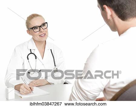 "Young female doctor with glasses, male patient, talking" View Large Photo Image Stock Photo - "Young female doctor with glasses, male patient, talking". Fotosearch