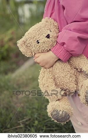 Stock Photography - "Young girl, 1 - 2 years, holding a teddy bear". Fotosearch