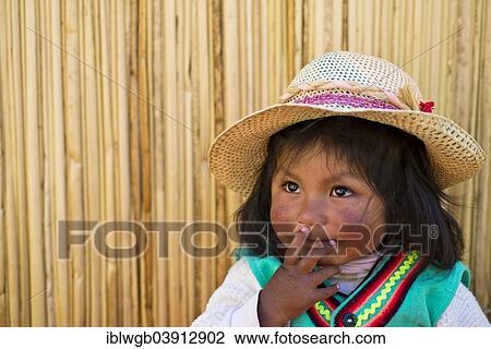 "Young girl of the Uro Indians, about 6 years old, wearing traditional dress in front of a reed hut, floating islands made of totora reeds, Lake Titicaca, southern Peru, Peru, South America" View Large Photo Image Stock Image - "Young girl of the Uro Indians, about 6 years old, wearing traditional dress in front of a reed hut, floating islands made of totora reeds, Lake Titicaca, southern Peru, Peru, South America". Fotosearch