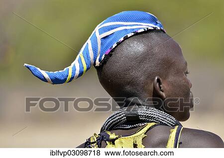 "Young Himba man wearing a traditional headdress, cap in the form of a cattle horn, Omohanja, Kaokoland, Kunene, Namibia, Africa" View Large Photo Image Stock Photo - "Young Himba man wearing a traditional headdress, cap in the form of a cattle horn, Omohanja, Kaokoland, Kunene, Namibia, Africa". Fotosearch