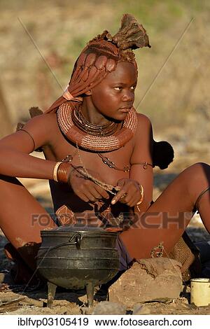 "Young Himba woman cooking on a campfire, Ombombo, Kaokoland, Kunene, Namibia, Africa" View Large Photo Image Stock Photo - "Young Himba woman cooking on a campfire, Ombombo, Kaokoland, Kunene, Namibia, Africa". Fotosearch