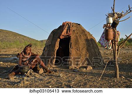 "Young Himba woman sitting at a campfire in front of her hut, Ombombo, Kaokoland, Kunene, Namibia, Africa" View Large Photo Image Stock Image - "Young Himba woman sitting at a campfire in front of her hut, Ombombo, Kaokoland, Kunene, Namibia, Africa". Fotosearch