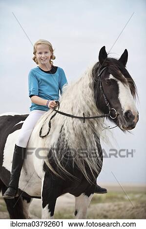 "Young horserider riding bareback on a mare, pony, Tinker, black and white chequered, in the dunes at the beach, Borkum, Lower Saxony, Germany, Europe" View Large Photo Image Stock Image - "Young horserider riding bareback on a mare, pony, Tinker, black and white chequered, in the dunes at the beach, Borkum, Lower Saxony, Germany, Europe". Fotosearch