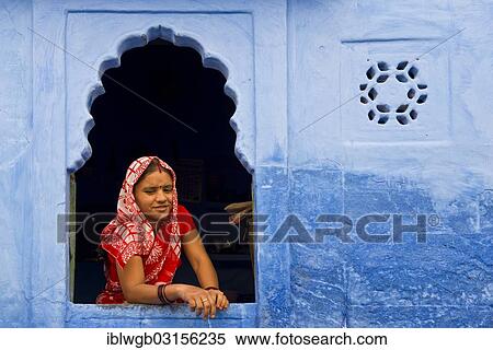 "Young Indian woman with headscarf looking out the window of a blue residential house, Jodhpur, Rajasthan, India, Asia" View Large Photo Image Stock Photography - "Young Indian woman with headscarf looking out the window of a blue residential house, Jodhpur, Rajasthan, India, Asia". Fotosearch