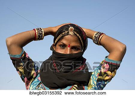 "Young Indian woman with jewellery and a bindi covering her face with a black veil, Pushkar, Rajasthan, India, Asia" View Large Photo Image Stock Image - "Young Indian woman with jewellery and a bindi covering her face with a black veil, Pushkar, Rajasthan, India, Asia". Fotosearch