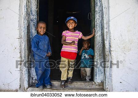"Young kids standing in a door frame, near Keren, Eritrea, Africa" View Large Photo Image Stock Image - "Young kids standing in a door frame, near Keren, Eritrea, Africa". Fotosearch