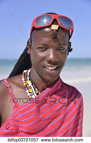 "Young Maasai man wearing traditional dress and sunglasses on the beach, Dongwe Beach, Dongwe, Zanzibar, Tanzania, Africa" View Large Photo Image Stock Photo - "Young Maasai man wearing traditional dress and sunglasses on the beach, Dongwe Beach, Dongwe, Zanzibar, Tanzania, Africa". Fotosearch