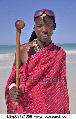 "Young Maasai man wearing traditional dress and sunglasses on the beach, Dongwe Beach, Dongwe, Zanzibar, Tanzania, Africa" View Large Photo Image Stock Photo - "Young Maasai man wearing traditional dress and sunglasses on the beach, Dongwe Beach, Dongwe, Zanzibar, Tanzania, Africa". Fotosearch