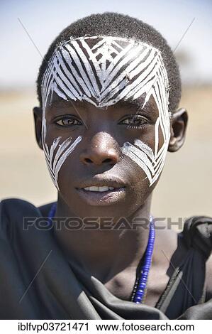 "Young Maasai warrior with a painted face, Ngorongoro Conservation Area, Ndema, Tanzania, Africa" View Large Photo Image Stock Image - "Young Maasai warrior with a painted face, Ngorongoro Conservation Area, Ndema, Tanzania, Africa". Fotosearch