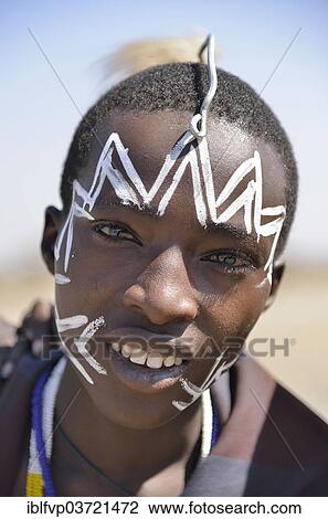 "Young Maasai warrior with a painted face, Ngorongoro Conservation Area, Ndema, Tanzania, Africa" View Large Photo Image Stock Image - "Young Maasai warrior with a painted face, Ngorongoro Conservation Area, Ndema, Tanzania, Africa". Fotosearch