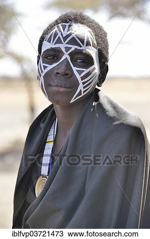 "Young Maasai warrior with a painted face, Ngorongoro Conservation Area, Ndema, Tanzania, Africa" View Large Photo Image Stock Image - "Young Maasai warrior with a painted face, Ngorongoro Conservation Area, Ndema, Tanzania, Africa". Fotosearch