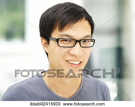 Young man, Asian, student with glasses, smiling View Large Photo Image Stock Image - Young man, Asian, student with glasses, smiling. Fotosearch