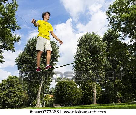 "Young man balancing on a slackline, Waiblingen, Baden-Wurttemberg, Germany, Europe" View Large Photo Image Stock Image - "Young man balancing on a slackline, Waiblingen, Baden-Wurttemberg, Germany, Europe". Fotosearch