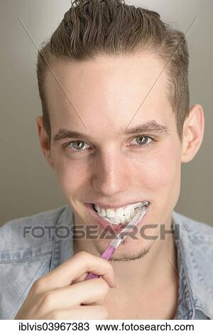 Young man brushing his teeth View Large Photo Image Stock Image - Young man brushing his teeth. Fotosearch