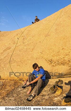 "Young man climbing at Bogenfels, Spitzkoppe area, Damaraland, Namibia, Africa" View Large Photo Image Stock Photography - "Young man climbing at Bogenfels, Spitzkoppe area, Damaraland, Namibia, Africa". Fotosearch