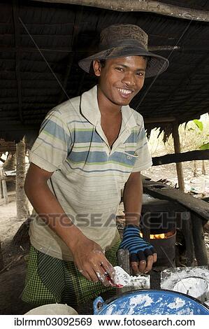 Stock Photo - "Young man during the production of fresh rice noodles, Siem Reap, Siem Reap Province, Cambodia, Asia". Fotosearch