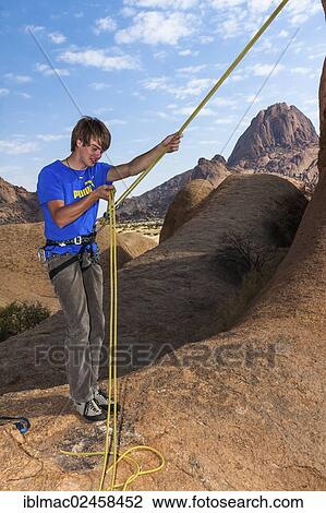 "Young man hanging from a climbing rope, Bogenfels, Spitzkoppe area, Namibia, Africa" View Large Photo Image Stock Image - "Young man hanging from a climbing rope, Bogenfels, Spitzkoppe area, Namibia, Africa". Fotosearch