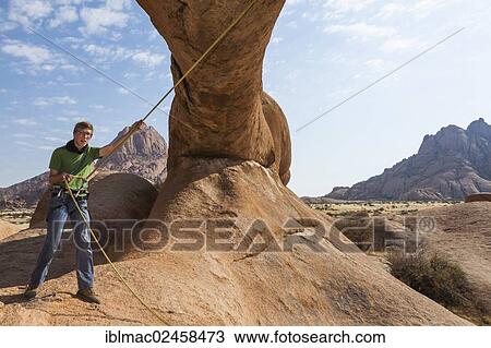 "Young man hanging from a climbing rope, Bogenfels, Spitzkoppe area, Namibia, Africa" View Large Photo Image Stock Image - "Young man hanging from a climbing rope, Bogenfels, Spitzkoppe area, Namibia, Africa". Fotosearch