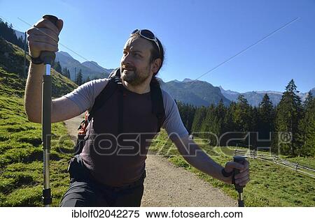 "Young man hiking with trekking poles on one of the hiking trails in the Berchtesgadener Land, Gotzenalm alp, Schoenau, Koenigssee, Bavaria, Germany, Europe" View Large Photo Image Stock Photography - "Young man hiking with trekking poles on one of the hiking trails in the Berchtesgadener Land, Gotzenalm alp, Schoenau, Koenigssee, Bavaria, Germany, Europe". Fotosearch
