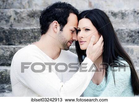 "Young man holding a young woman's head, Austria, Europe" View Large Photo Image Stock Image - "Young man holding a young woman's head, Austria, Europe". Fotosearch